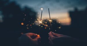 Picture of two hands holding sparklers. Christian Hope