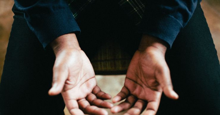 Open hands on a bible in opening prayer